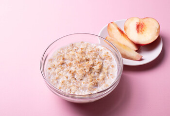 morning oat meal in a glass bowl with peaches 