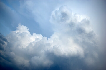 Naklejka na ściany i meble Pre-storm Cumulus blue clouds in the evening sky