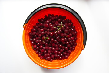 Cherries on a white background. Cherries in a basket on a white background. Top view.