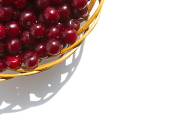 Cherries on a white background. Cherries in a basket on a white background. Top view.