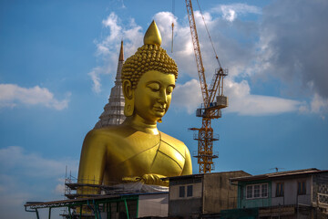 Close-up natural background of the waterfront community, a large Buddha statue (Wat Paknam Phasi Charoen) stands beautifully, seen in tourist attractions in Bangkok, Thailand.