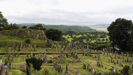 Fototapeta na wymiar Stirling, Scotland - August 1, 2020, old medieval cemetery around Port of Menteith Parish Church.