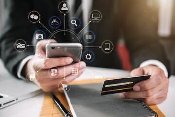 Male businessman use credit cards to conduct financial transactions through smartphones.