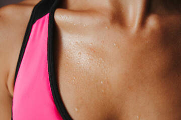 Intensive work out. Sweaty muscular body of sporty woman, close up. Fitness, activity, hydration...