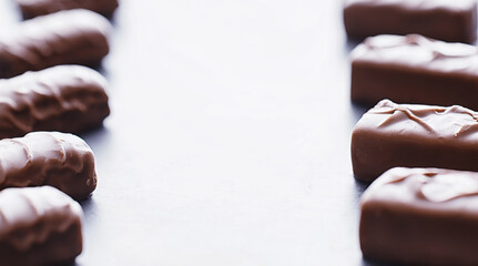 Chocolate bars on a black background in backlight. Chocolate with filling. Sweet sweets for snack and tea.