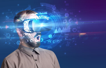 Businessman looking through Virtual Reality glasses with TESTING inscription, innovative technology concept