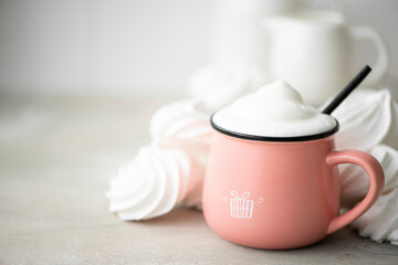 Fototapeta na wymiar coffee latte in a large pink mug with white marshmallows