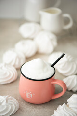 coffee latte in a large pink mug with white marshmallows