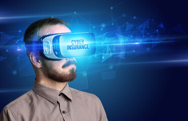 Businessman looking through Virtual Reality glasses with CYBER INSURANCE inscription, cyber security concept