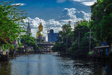 Fototapeta na wymiar Close-up natural background of the waterfront community, a large Buddha statue (Wat Paknam Phasi Charoen) stands beautifully, seen in tourist attractions in Bangkok, Thailand.
