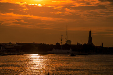 The blurred abstract background of the evening sun shining on the river is naturally golden yellow, the beauty of the clouds and the weather conditions of the day.