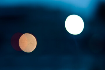 City traffic lights at night,  abstract blurry circles in rear view mirror