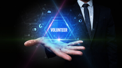 Man hand holding VOLUNTEER inscription, social media concept