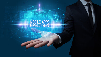 Man hand holding MOBILE APPS DEVELOPMENT inscription, technology concept