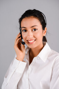isolated portrait of cheerful young brunette woman working as telephone operator hotline customer support