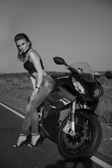 Fototapeta na wymiar Beautiful woman with a motorcycle and a cigarette