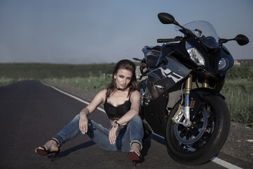 Obraz na płótnie Canvas Beautiful woman with a motorcycle