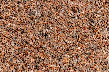 The pattern of dark brown small pebbles as background