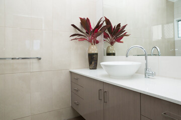 New modern ensuite bathroom with tiled walls, stone bench top and vanity unit