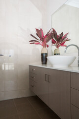 New modern ensuite bathroom with stone bench top, vanity basin and tiled walls