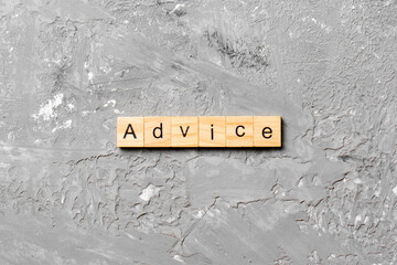 Advice word written on wood block. Advice text on table, concept
