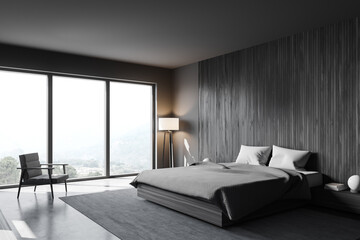 Grey and wooden bedroom corner with armchair