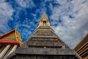 Fototapeta premium background of important religious attractions in Bangkok (Wat Phra Chetuphon (Wat Pho - reclining Buddha), a large pagoda and beautiful sculptural art give future generations to explore its history