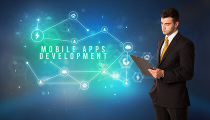 Businessman in front of cloud service icons with MOBILE APPS DEVELOPMENT inscription, modern technology concept