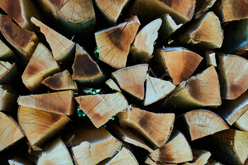 Brown uneven pieces of firewood, filling the picture, Germany.