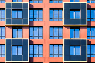 Obraz premium Exterior of modern architecture in the city center. Construction abstract background. Detail of the facade with windows.