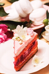 Obraz na płótnie Canvas Pink cake with white flowers and white zephyr