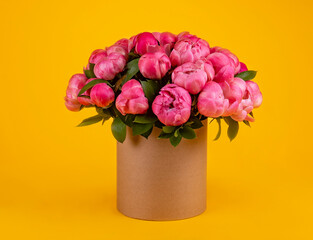 Lush bouquet of red peonies in a card box