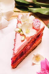 Slice of pink cake with white flowers