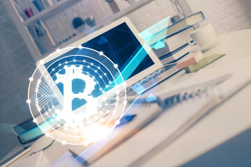 Multi exposure of blockchain theme hologram and table with computer background. Concept of bitcoin...