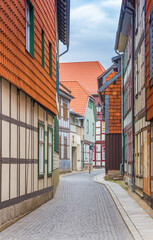 Fototapeta na wymiar Narrow street with half timbered houses in the historic center of Wernigerode, Germany