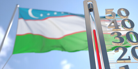 Thermometer shows high air temperature against blurred flag of Uzbekistan. Hot weather forecast related 3D rendering
