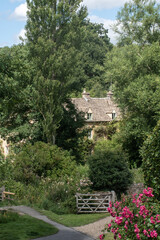 Fototapeta na wymiar English Country cottage in idyllic setting in Cotswolds