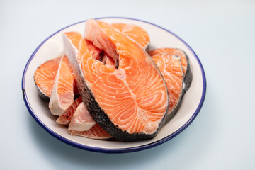 fresh raw salmon on the dish on blue background