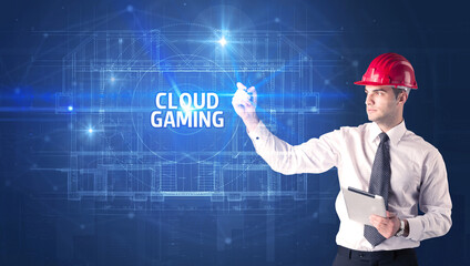 Handsome architect with helmet drawing CLOUD GAMING inscription, new technology concept