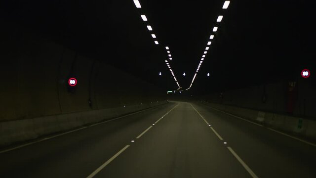 Driving through empty road tunnel 