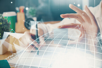 Double exposure of hands making notes with world map hologram and data theme icons. Concept of global computer data.