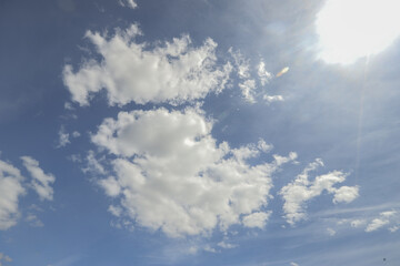 Naklejka na ściany i meble background of blue sky and white clouds. High quality photo