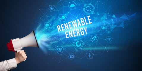 Young woman shouting in megaphone with RENEWABLE ENERGY inscription, Modern technology announcement concept