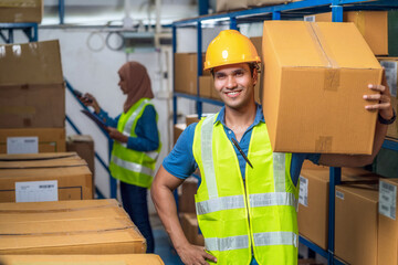 Idian worker man holding cardboard box and walking with Muslim worker woman scanning bar code and...