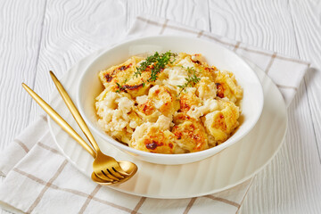 Vegan cauliflower cheese gratin on a white plate