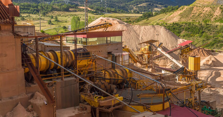 Panoramic view of gravel stone crushing mills with ribbons and gravel distribution according to sizes in gravel pit outdoor terraces and deposits of waste coal power plant 