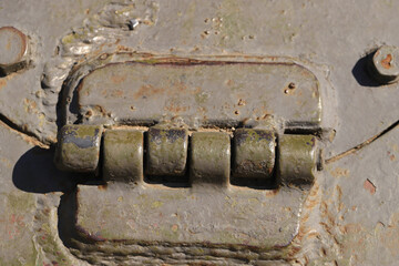Detail of an old surface with exfoliated paint and rivets on military equipment. Military background. High quality photo