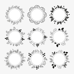 Round wreaths with simple doodle black and outline leafy twigs, wild herbs, plants, berries, empty space for text isolated on white background.