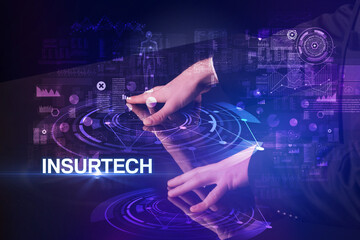 Businessman touching huge display with INSURTECH inscription, modern technology concept