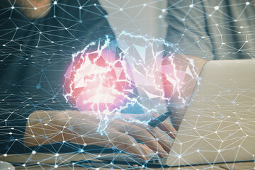 Businessman with computer background with brain theme hologram. Concept of brainstorm. Multi exposure.